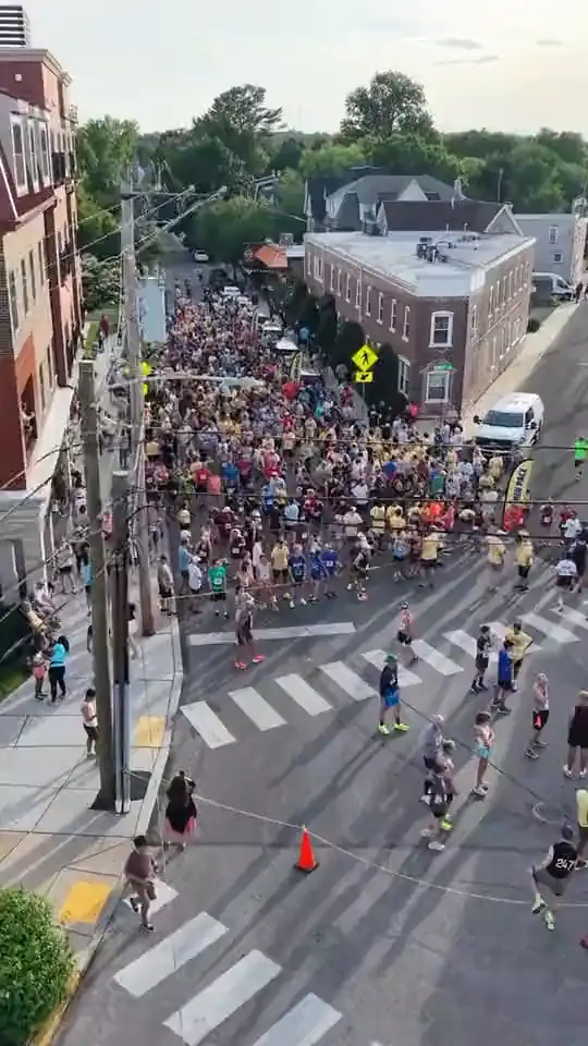 Aerial view of runners filling the street at the start line in Jenkintown